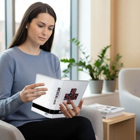 Family Medical Records Binder - Mini Binder woman holding a small 3 ring binder.