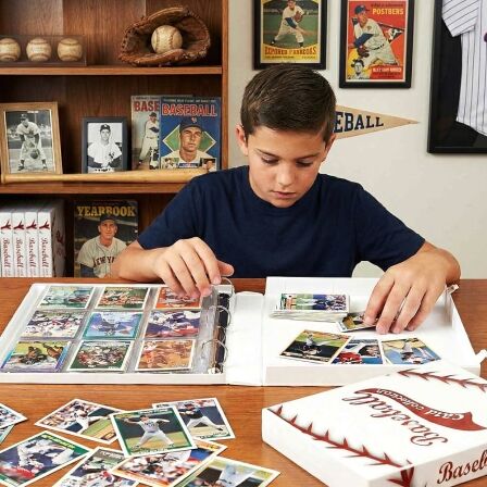 XL Baseball Trading Card Storage Kit - Includes 20 Card Pages and Metal Binder Rings kid organizing baseball cards in a sports card binder